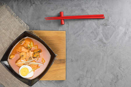 Sum tomato with shrimps and mussels on the plate on the serving Board at a beautiful stone table....