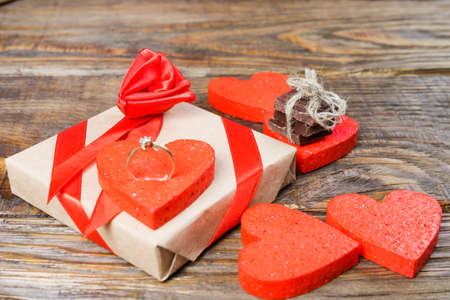 The gift is Packed in Kraft paper and tied with a red ribbon rose. Gift wraps on a heart of the worldの写真素材