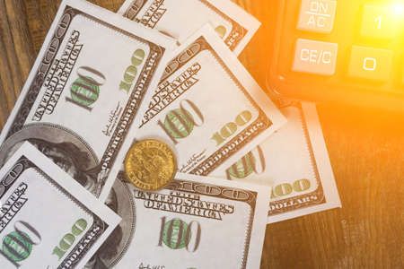 Banknotes, coins calculator on the wood table. Copy paste.の写真素材