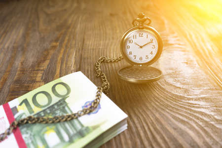 Pocket watch associated with cash in the tree. Time is money. Copy pasteの写真素材