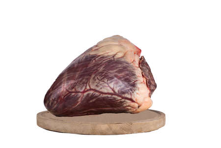 Beef heart cut in half on a cutting board. isolate on white background. copy spaseの写真素材