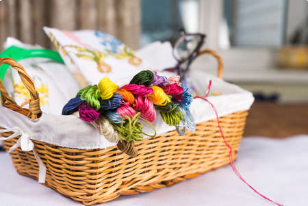 embroidery and all necessary for this hobby. Thread scissors embroidery Hoop in a wicker basket. Copy pasteの写真素材