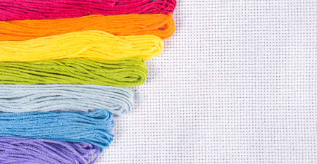 Colored thread for embroidery on white canvasの写真素材