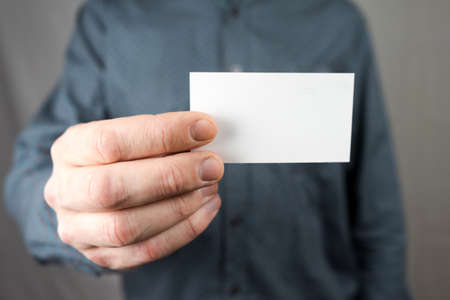 Businessman holding a business card. Mock upの写真素材