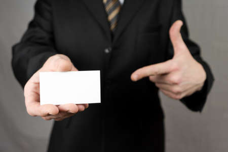 Businessman holding a business card. Mock upの写真素材