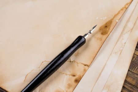 Mock up. Pile of old manuscripts of the old fountain pen on a wooden table. Copy space.の写真素材