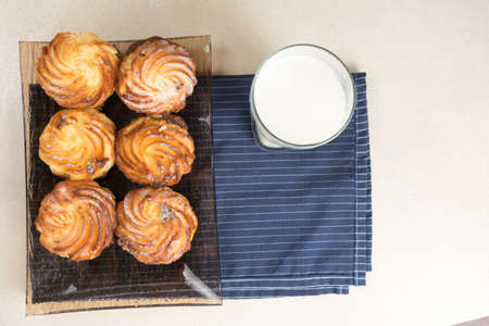 Chocolate cheesecake cupcakes and a glass of milk for Breakfast. Top view. Copy spase.の写真素材