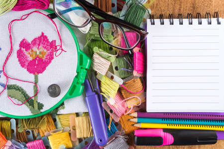 Hoops with canvas colored thread, scissors and a notebook for diagrams ..の写真素材