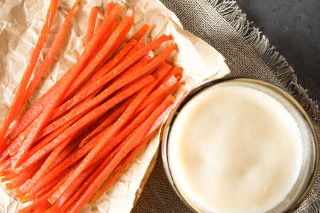 Dark beer, nachos and fish chips are on the tableの写真素材