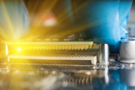 A gloved hand, placing a CPU on the motherboard