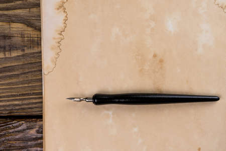 Mock up. Pile of old ancient manuscripts of the old fountain pen on a wooden table.の写真素材