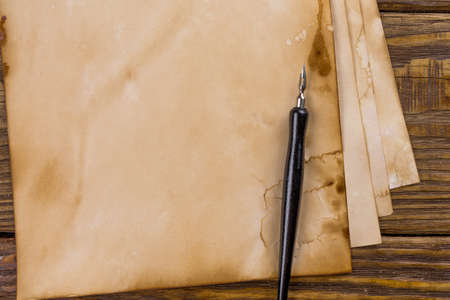 Mock up. Pile of old ancient manuscripts of the old fountain pen on a wooden table.の写真素材