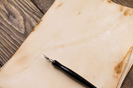 Mock up. Pile of old ancient manuscripts of the old fountain pen on a wooden table.の写真素材