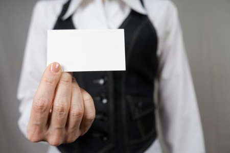 Businesswoman holding a business card. Mock up. Copy space.の写真素材
