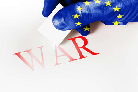 Hand textured flag eraser to erase the word war. Concept of peaceの写真素材