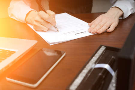 A businessman puts his signature on the contract.