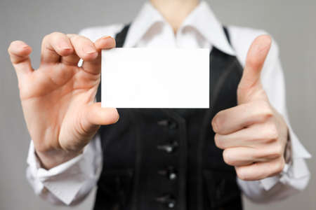 Businesswoman holding a business card. Mock up.の写真素材