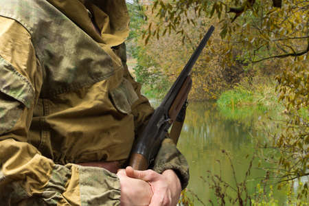 Man hunting with a hunting rifle. Early morning