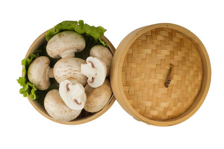 White mushrooms in a bamboo round container.の写真素材