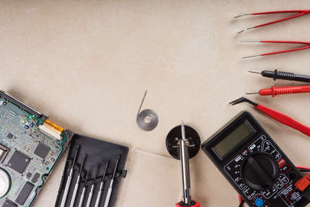 Multimeter, soldering tool and hand tools for electronics assembly.