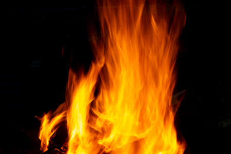 Flames of fire from burning coals in the grill late at night. Copy paste.