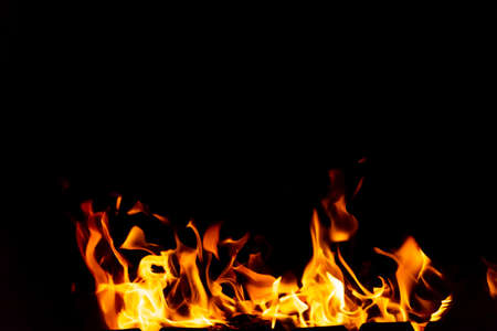 Flames of fire from burning coals in the grill late at night. Copy paste.