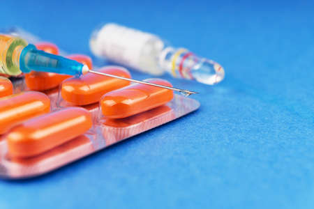 Tablets in a blister, a syringe with the typed medical preparation and an ampoule with a pharmaceutical preparation.の写真素材