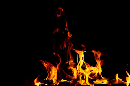 Flames of fire from burning coals in the grill late at night. Copy paste.の写真素材