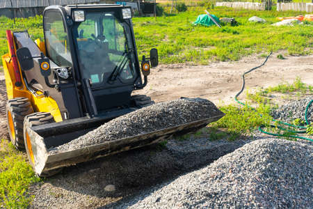 The loader picked up rubble in the bucket for construction work. Copy paste.の写真素材