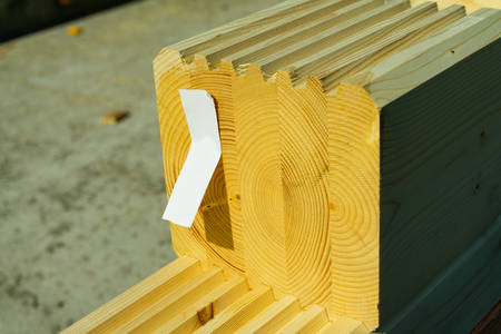 Construction of a wooden house made of profiled laminated veneer lumber. Bookmark corners.