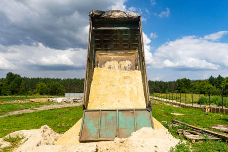 The dump truck unloads sand.の写真素材