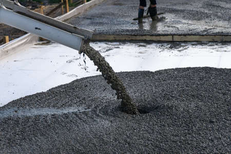 Workers pour the Foundation for the construction of a residential building using mobile concrete mixers.の写真素材