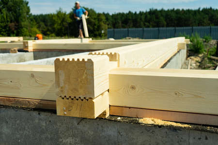 Construction of a wooden house made of profiled laminated veneer lumber. Bookmark corners.の写真素材