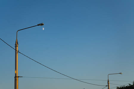 Lamppost on the background of the evening sky with the rays of the setting sun.の写真素材
