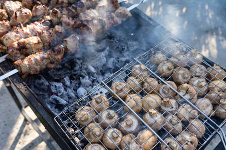 Barbecue on the grill. Cooking mushrooms on the grillの写真素材
