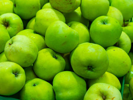 Bunch of green and red apples on boxes in supermarket.の写真素材