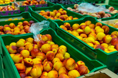 Peaches Packed boxes lying on the counter of the supermarket.の写真素材