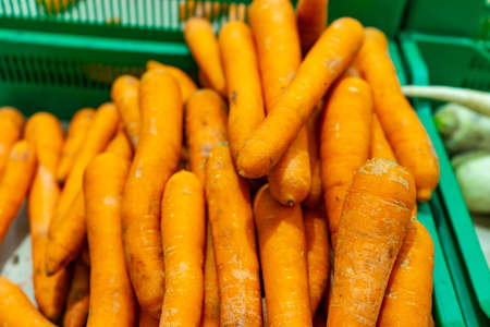 Carrot in plastic boxes in a vegetable shop.の写真素材
