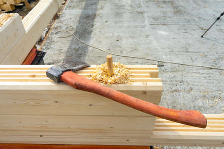 Construction of the house from a bar. Drilling holes and clogging of dowels.の写真素材