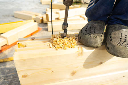 Drilling holes in laminated veneer lumber for shkantov.の写真素材