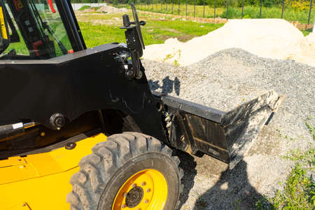 The loader picked up rubble in the bucket for construction work. Copy paste.の写真素材