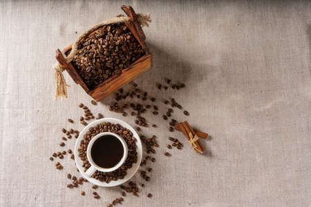 Coffee cup and beans on old kitchen tableの写真素材