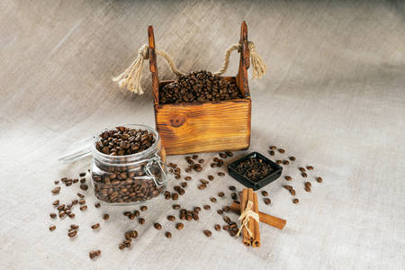 Coffee beans in a container, cinnamon, nutmeg and clovesの写真素材