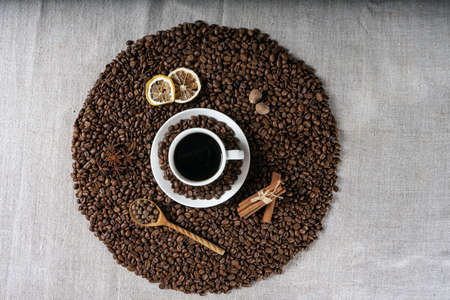 Coffee cup and beans on old kitchen tableの写真素材