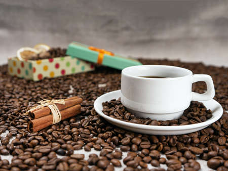 Coffee cup and beans on old kitchen tableの写真素材