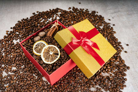Loose coffee beans, gift box with dried lemon coffee beans and cinnamon sticksの写真素材