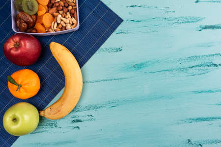 Lunch box with appetizing food and on light wooden tableの写真素材