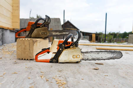When construction a wooden house, two chainsaws a bitの写真素材