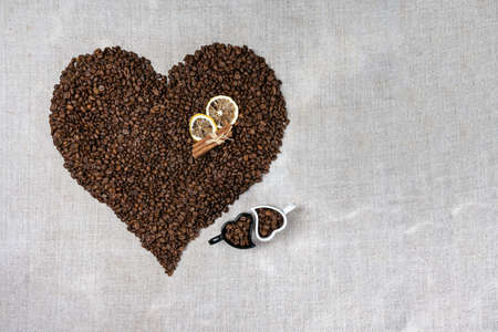 Coffee cup and beans on old kitchen tableの写真素材