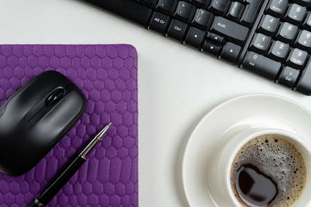 Flat lay, top view office table desk. Workspace with note book, keyboard, office supplies and coffee cup on white background.の写真素材